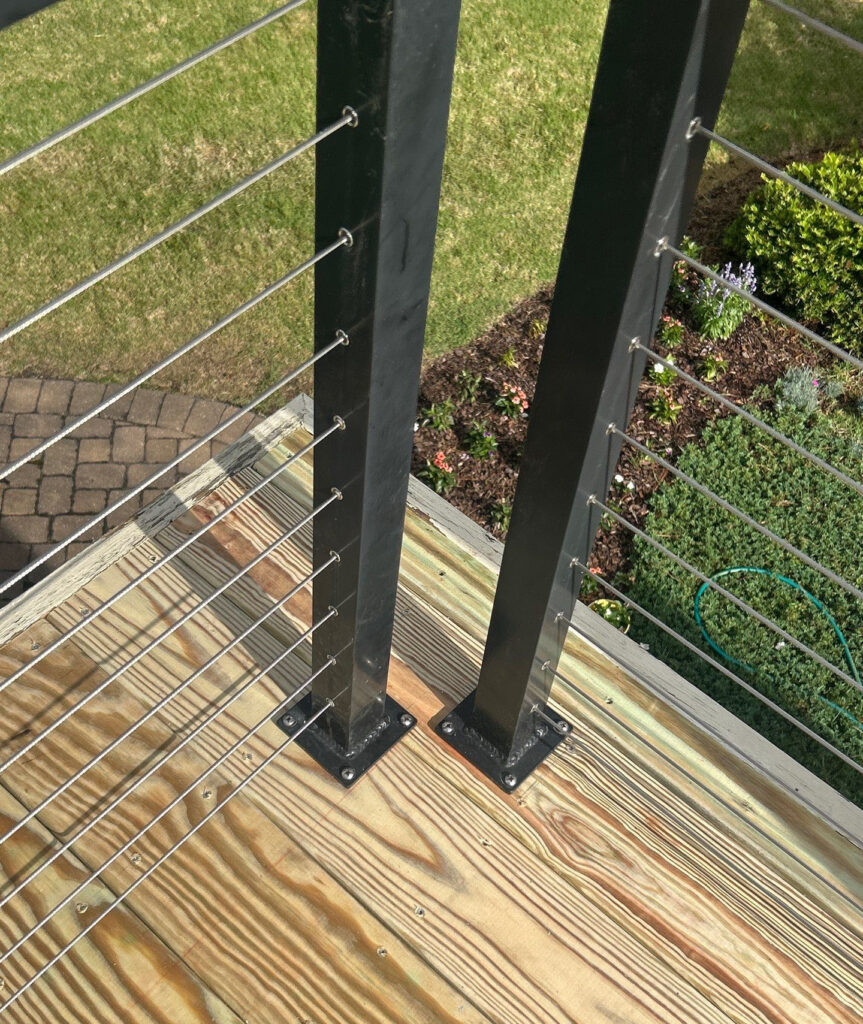 Cable railing posts and base plates on timber decking at an RGR Southport project
