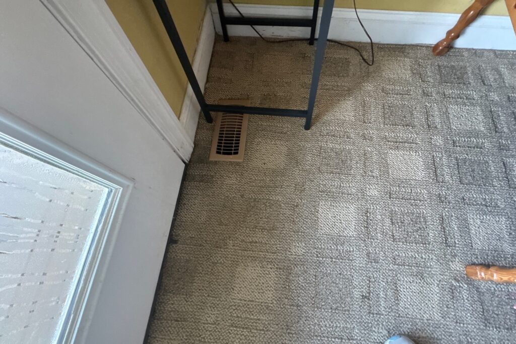 Carpeted floor and trim beside the repaired entry threshold in Oak Island, NC