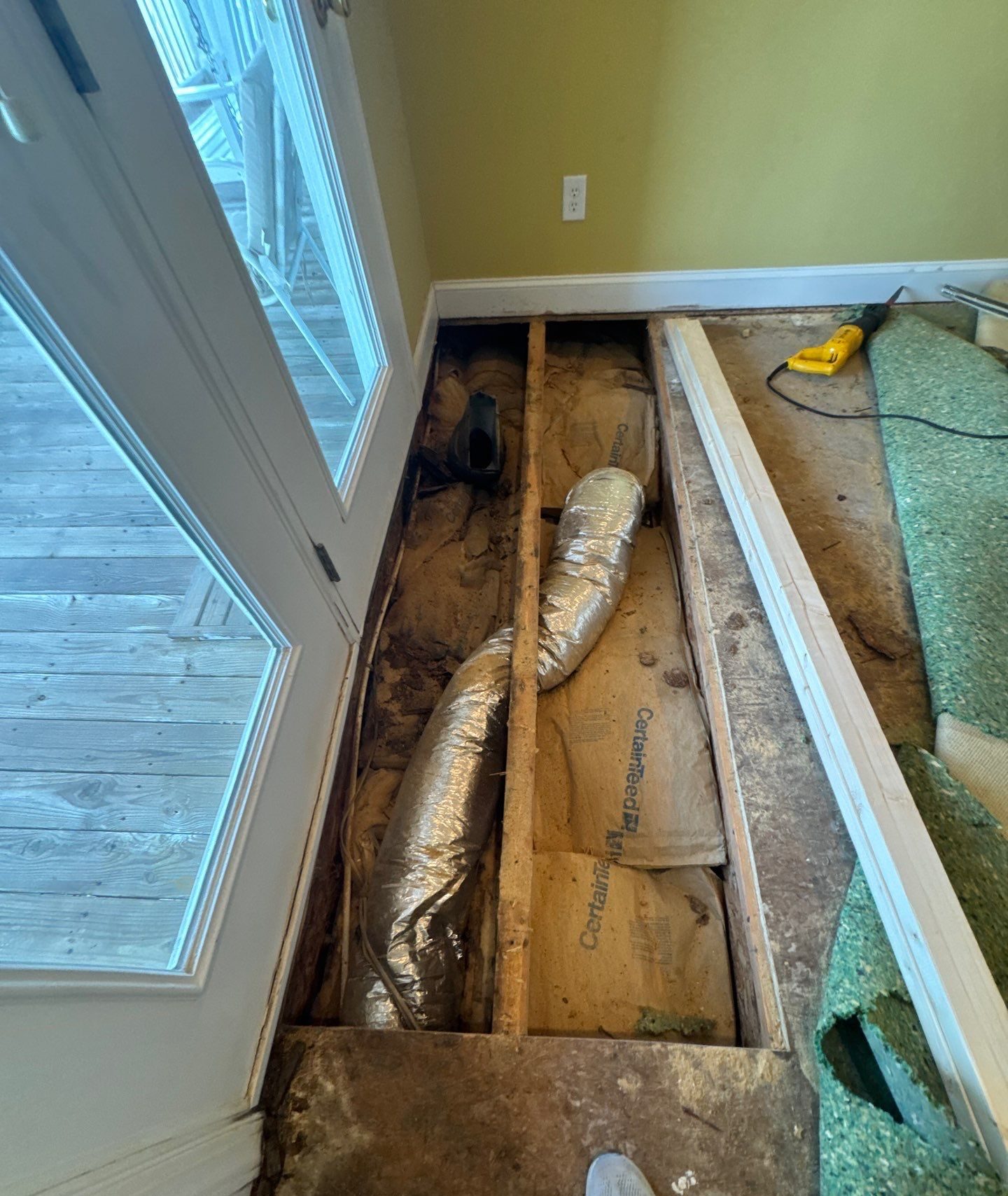 Open floor beside the door exposing joists and HVAC ductwork in Oak Island, NC