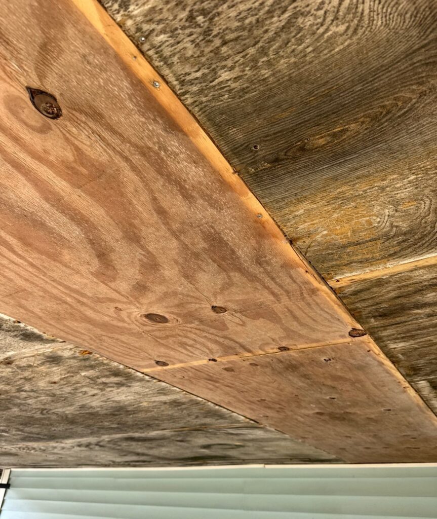 Replacement plywood closing an under-house ceiling strip in Oak Island