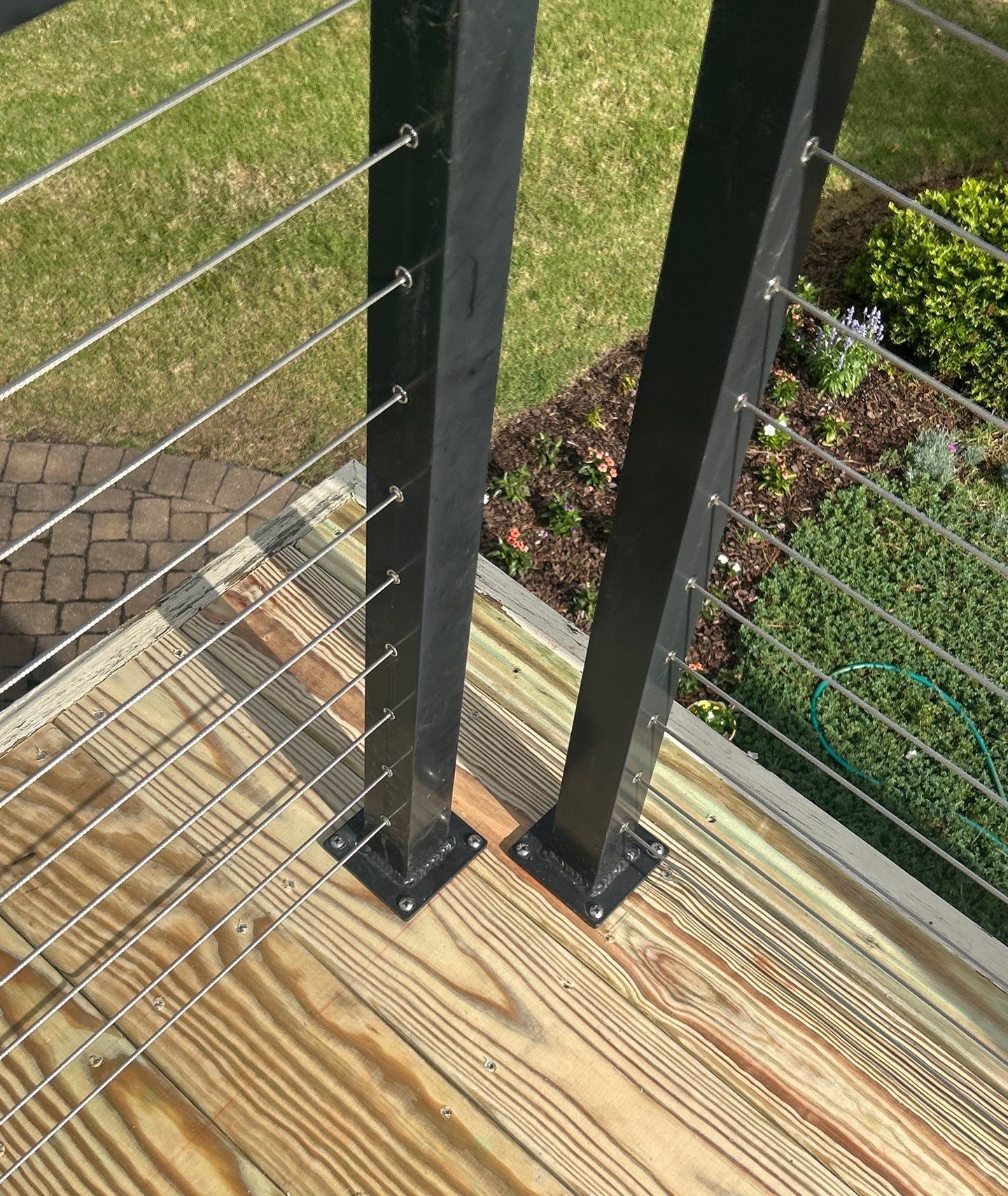 Cable railing and dark posts beside the wood deck boards in Southport, NC