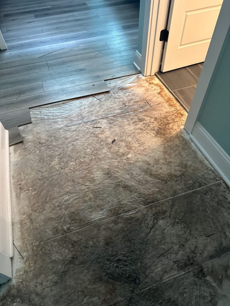 Opened floor covering beside the interior doorway in Oak Island, NC