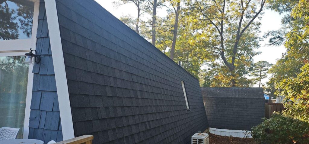 Dark shingles on the steep mansard roof section in Oak Island, NC