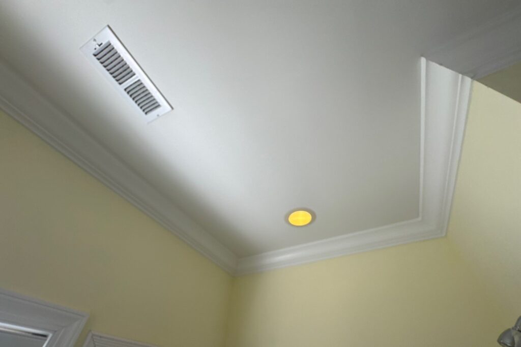 Bathroom ceiling and crown molding during a stain assessment in Oak Island