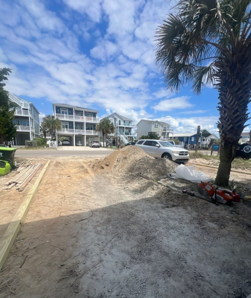 Driveway excavation and aggregate piles before concrete placement in Oak Island, NC