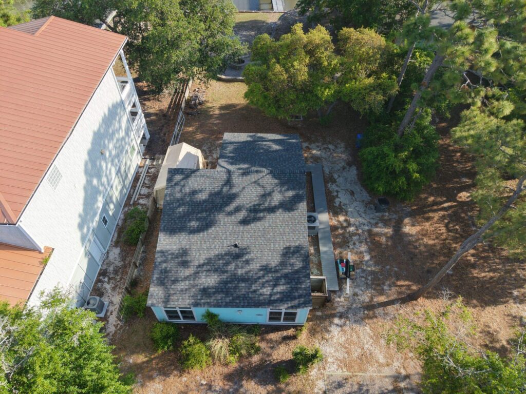 Aerial view of the low-roof section beside the taller home in Oak Island, NC