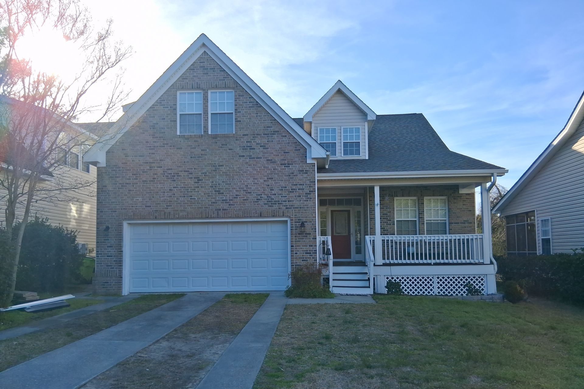 Shingle roof and dormer above the brick front elevation in Southport, NC