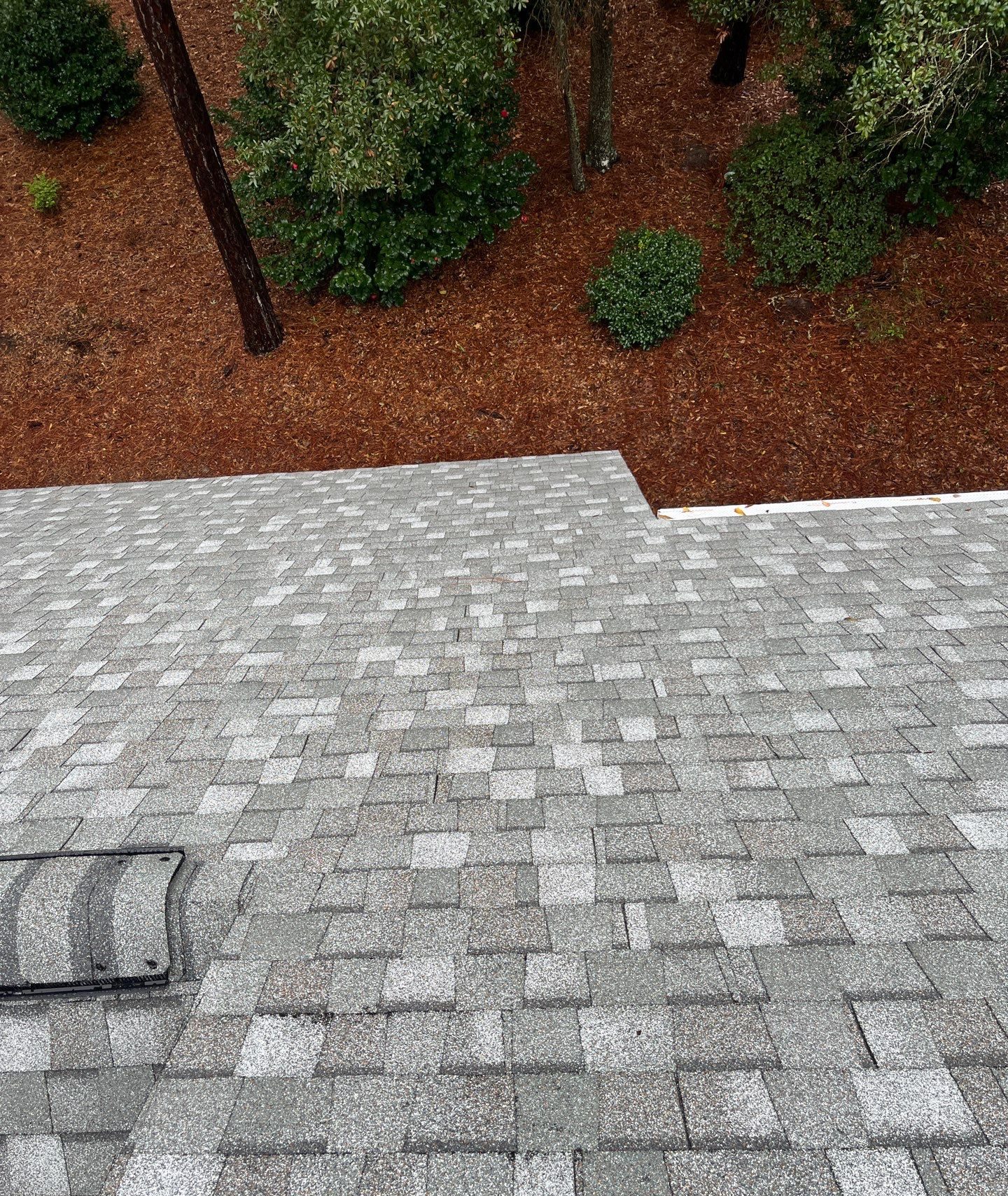 Close view of architectural shingle courses and ridge caps in Oak Island, NC