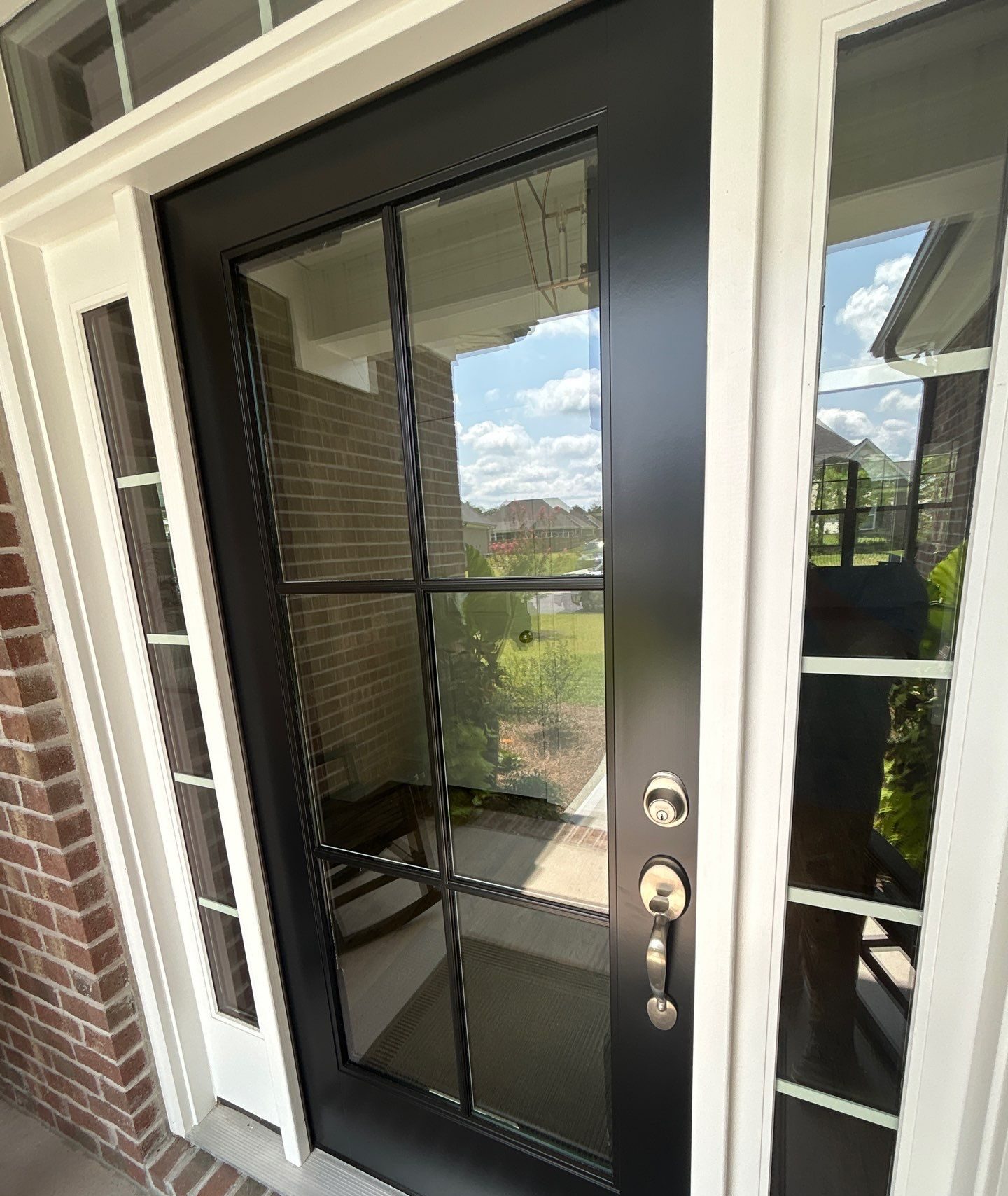 Black glazed entry door with sidelights and a transom in Bolivia, NC