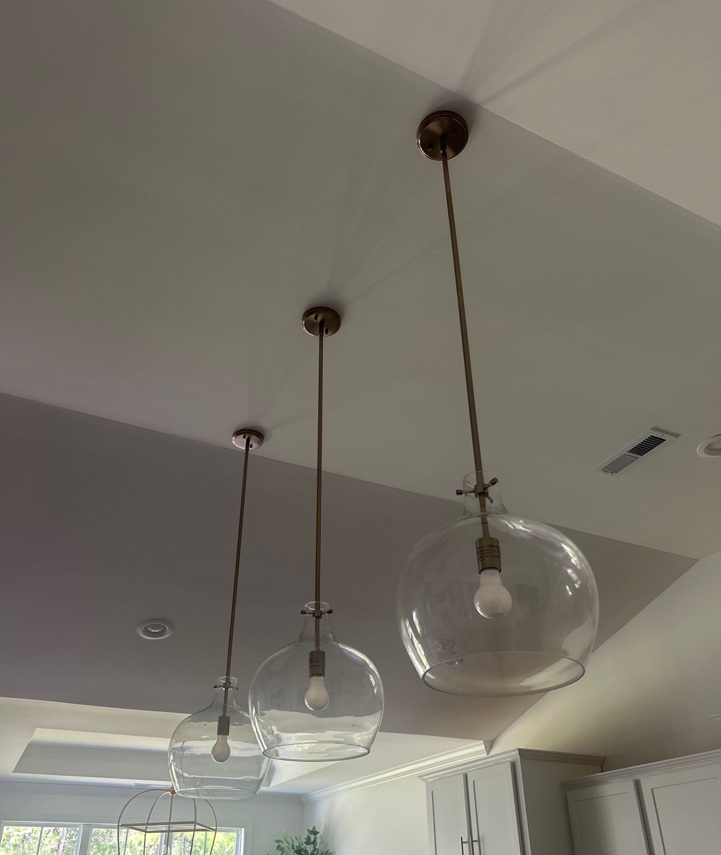 Three clear globe pendant lights above the interior space in Bolivia, NC