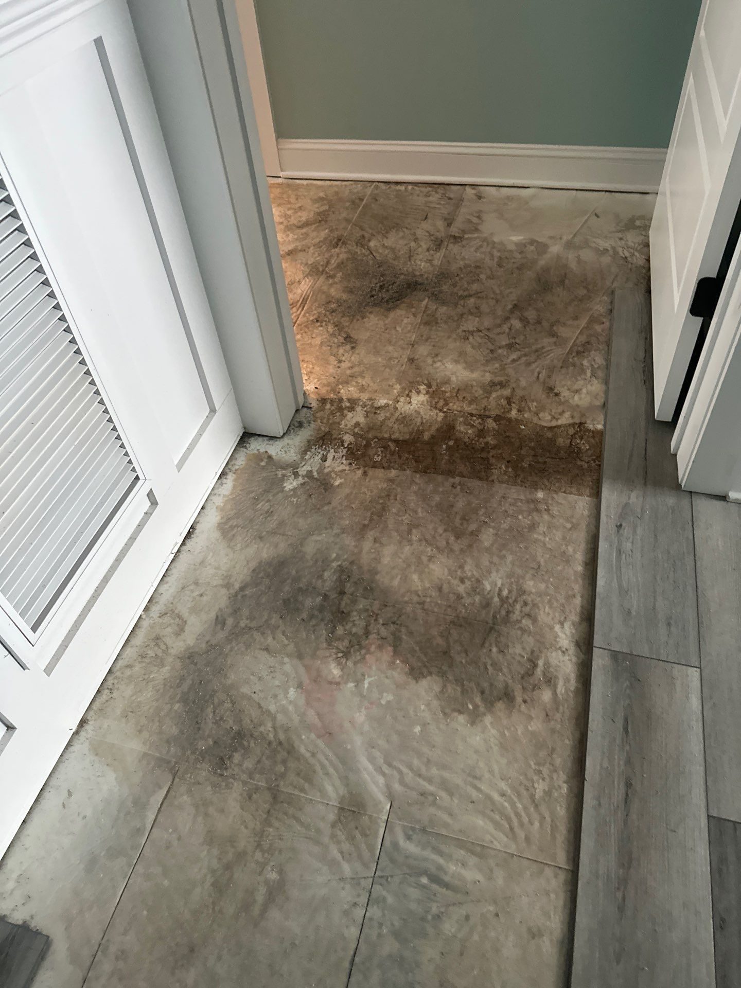 Floor repair area beside the white door and trim in Oak Island, NC