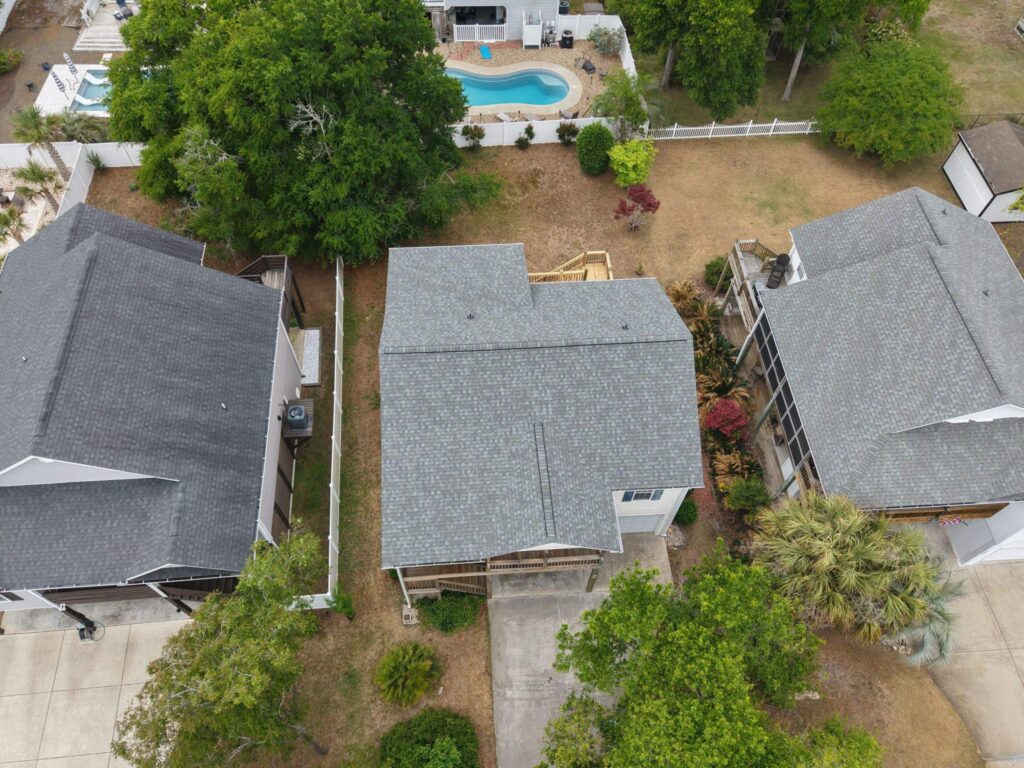 Wider aerial view of the home and adjoining properties in Oak Island, NC