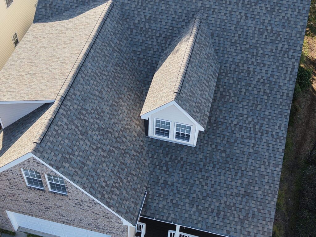 Steep shingle roof planes surrounding the dormer in Southport, NC