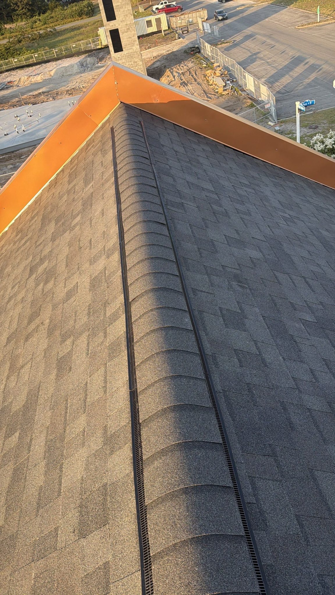 Shingle ridge beside the raised roof edge and orange trim in Sunset Beach, NC